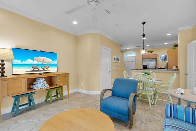 living room with ceiling fan, ornamental molding, and light tile patterned floors