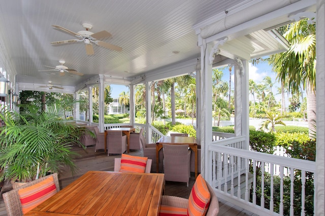 sunroom / solarium featuring ceiling fan