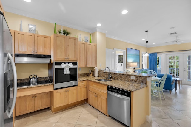 kitchen featuring sink, appliances with stainless steel finishes, light tile patterned flooring, decorative light fixtures, and kitchen peninsula