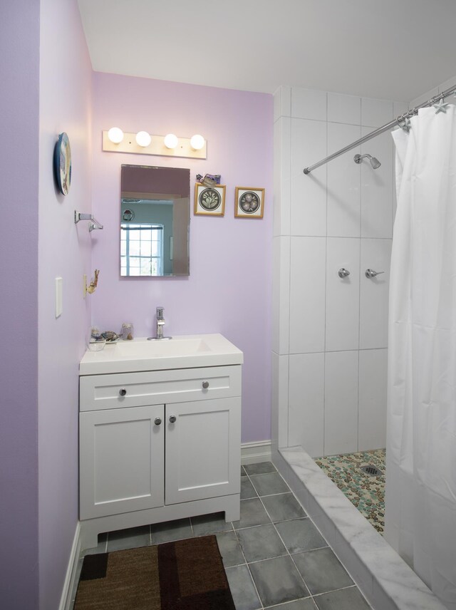 bathroom featuring vanity, tile patterned flooring, and a shower with shower curtain