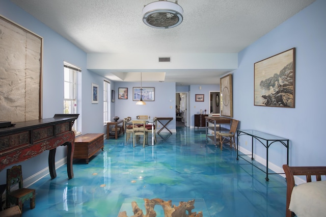 interior space with concrete floors and a textured ceiling