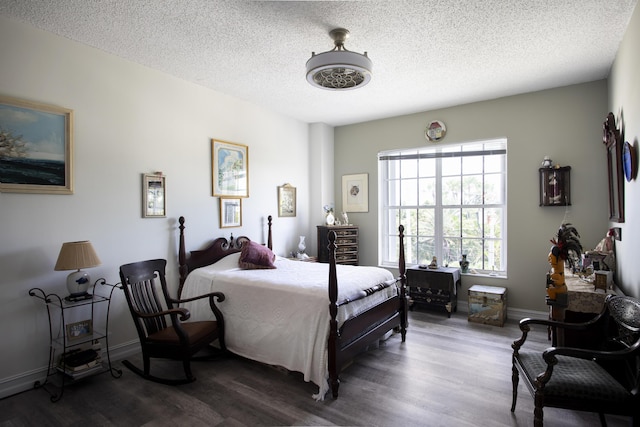 bedroom featuring hardwood / wood-style flooring and a textured ceiling