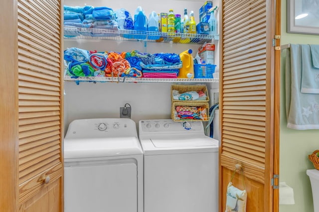 clothes washing area featuring separate washer and dryer