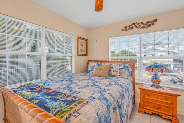 bedroom featuring light tile patterned flooring and ceiling fan