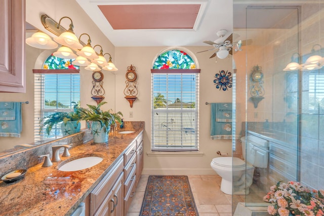 bathroom featuring walk in shower, tile patterned floors, toilet, vanity, and ceiling fan