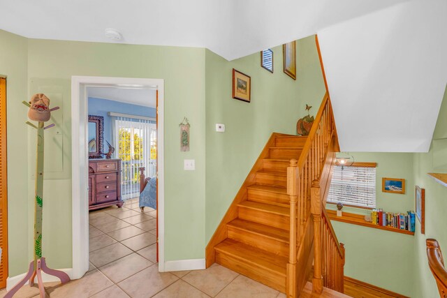 stairway with tile patterned floors