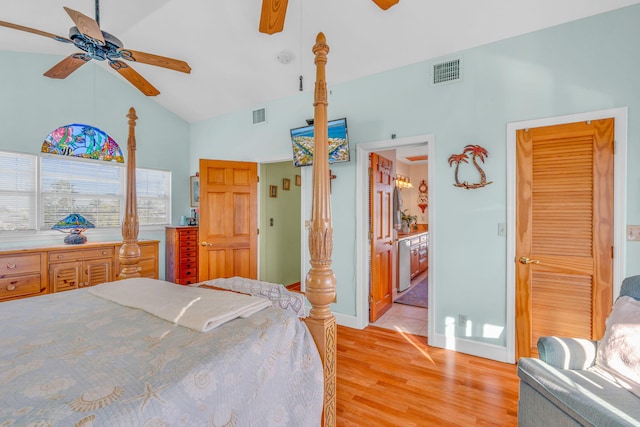 bedroom featuring vaulted ceiling, ensuite bathroom, ceiling fan, and light hardwood / wood-style floors