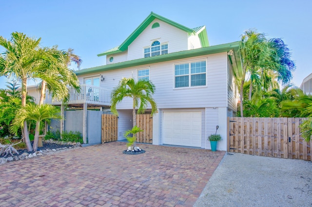 view of front of house featuring a garage and a balcony