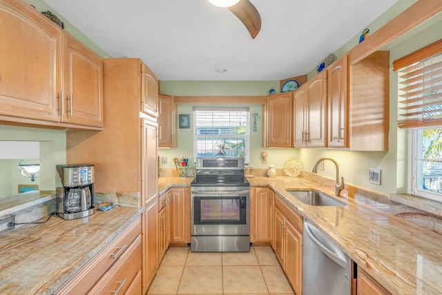 kitchen featuring light tile patterned flooring, appliances with stainless steel finishes, sink, and a wealth of natural light