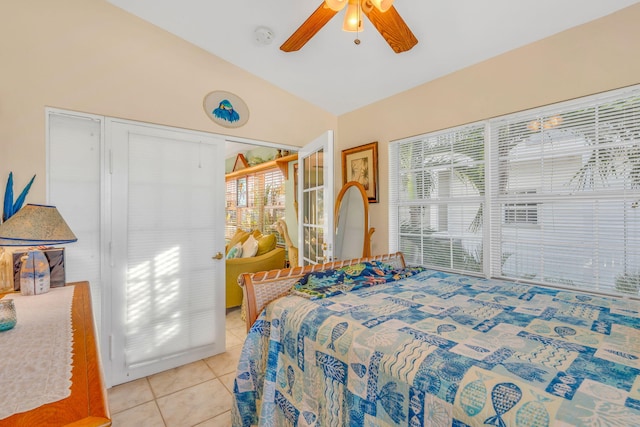 bedroom with vaulted ceiling, ceiling fan, and light tile patterned flooring