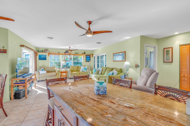 dining area featuring light tile patterned floors and ceiling fan