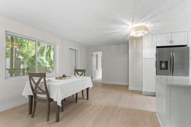 82260 Overseas Hwy, Islamorada, FL 33036 - dining space featuring light wood-style floors, baseboards, and a chandelier