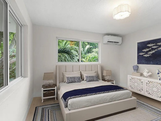 82260 Overseas Hwy, Islamorada, FL 33036 - bedroom with a wall mounted AC and wood finished floors