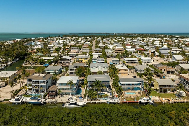 drone / aerial view featuring a residential view and a water view