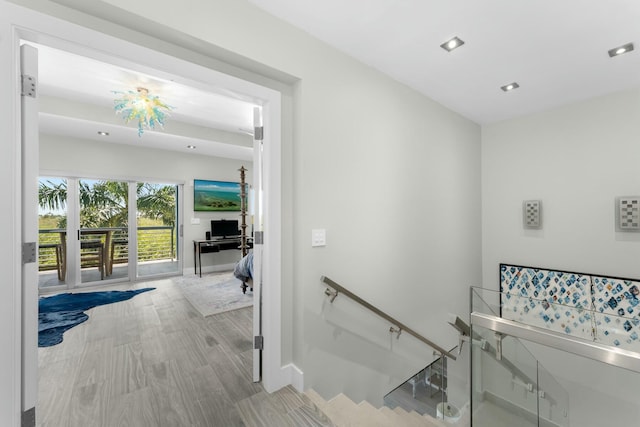 staircase with wood finished floors, recessed lighting, and baseboards