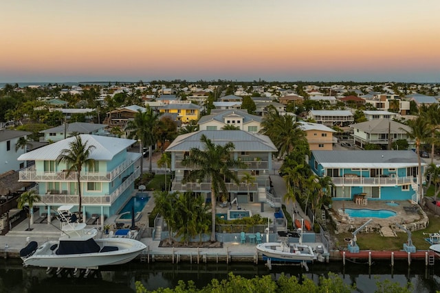 birds eye view of property with a residential view and a water view