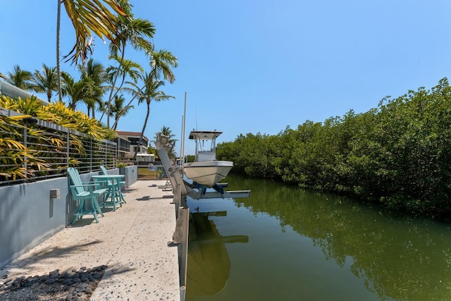 view of dock with boat lift and a water view