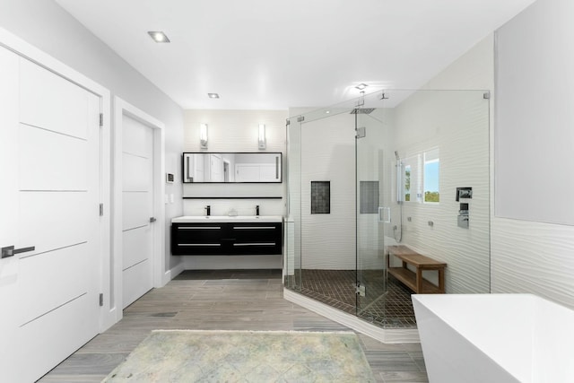 full bath with a freestanding tub, vanity, a shower stall, and recessed lighting