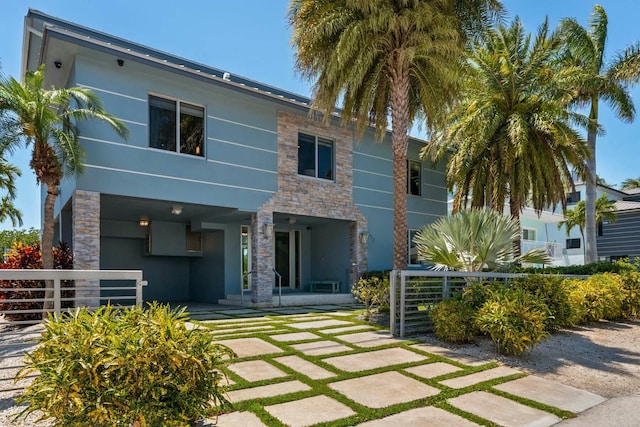 exterior space with stucco siding and stone siding
