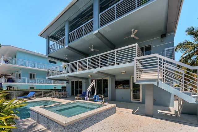 view of pool featuring ceiling fan, an in ground hot tub, and a patio area