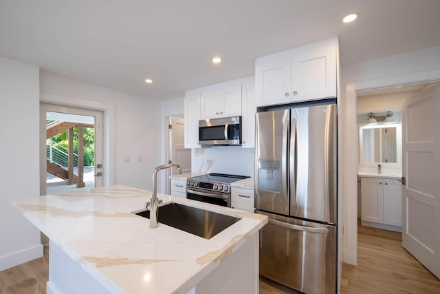 kitchen featuring stainless steel appliances, light wood-style flooring, white cabinetry, and recessed lighting