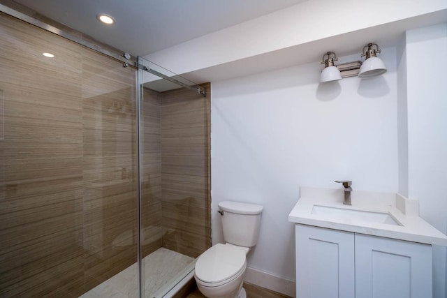 bathroom featuring recessed lighting, toilet, a tile shower, vanity, and baseboards