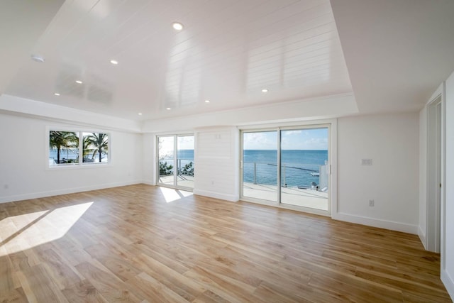 unfurnished living room featuring light wood-style floors, recessed lighting, and baseboards