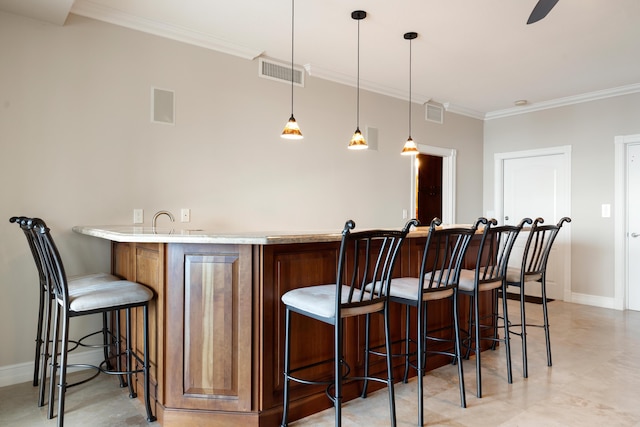 bar featuring hanging light fixtures and crown molding