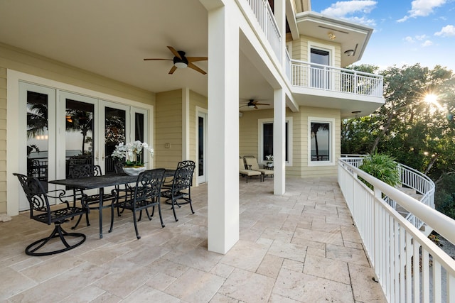 view of patio featuring a balcony, ceiling fan, and french doors