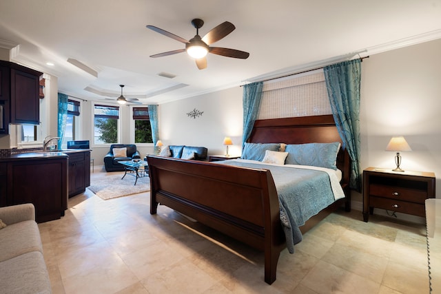 bedroom with ceiling fan, ornamental molding, a raised ceiling, and sink