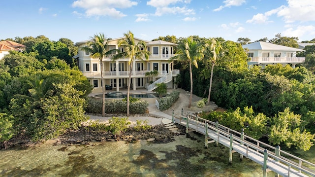 rear view of property with a balcony and a patio area