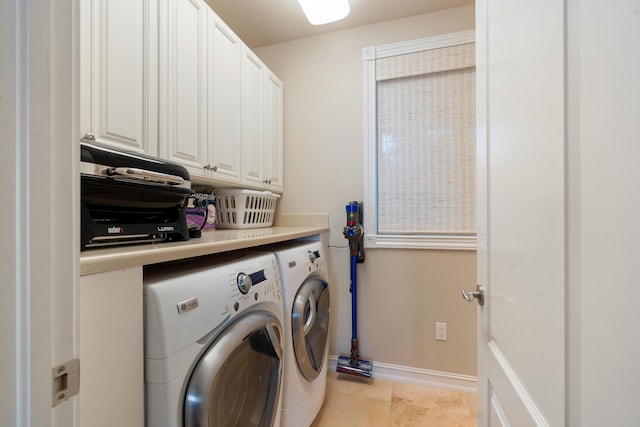 washroom featuring cabinets, washer and dryer, and light tile patterned flooring