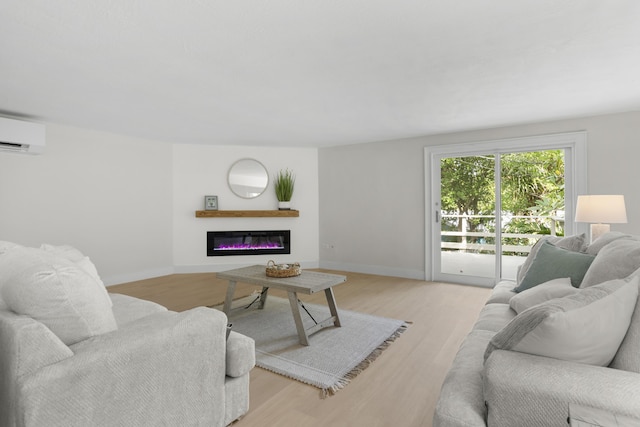 living room featuring light hardwood / wood-style flooring and an AC wall unit