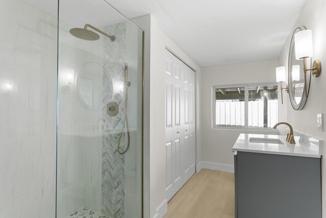 bathroom featuring vanity, a shower with shower door, and hardwood / wood-style floors