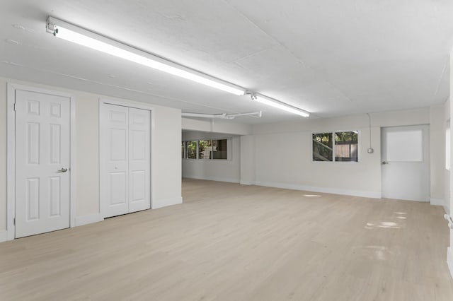 basement featuring light hardwood / wood-style floors and a wealth of natural light