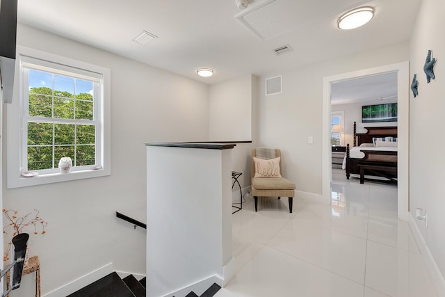 hall with light tile patterned floors