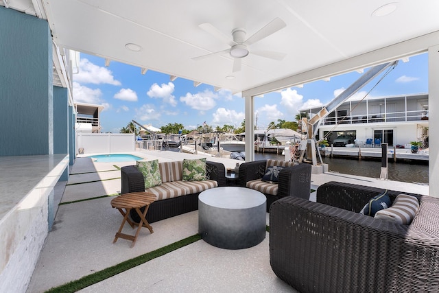 view of patio featuring a water view, ceiling fan, an outdoor hangout area, and a fenced in pool