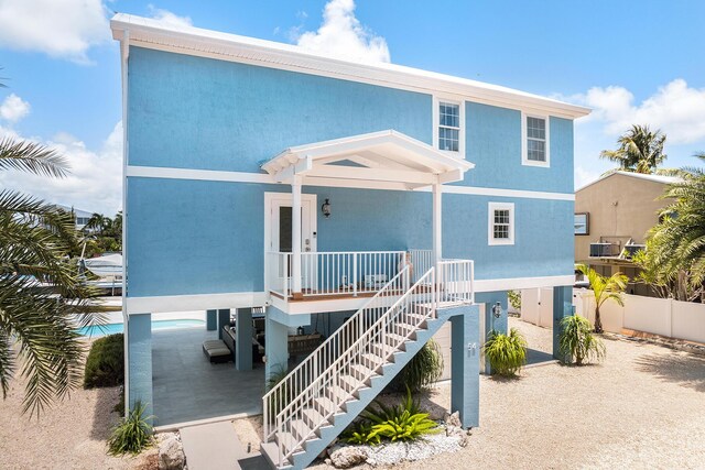 view of front of house featuring a carport and covered porch