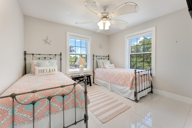 tiled bedroom with multiple windows and ceiling fan