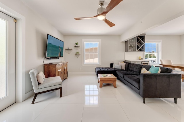 living room with light tile patterned floors and ceiling fan