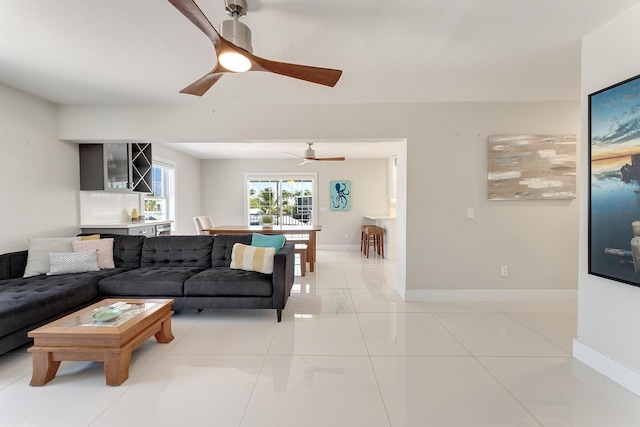 tiled living room with ceiling fan