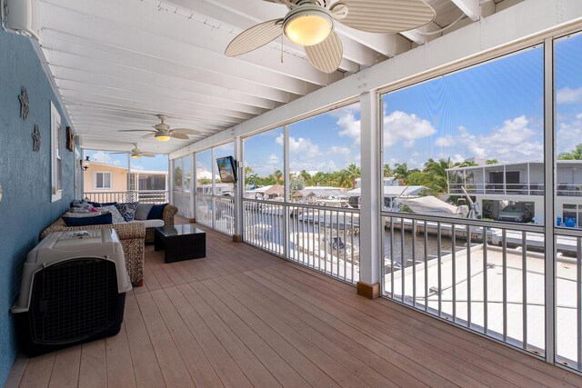 sunroom with a wealth of natural light and ceiling fan