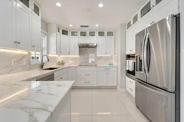 kitchen featuring appliances with stainless steel finishes, light stone countertops, sink, and white cabinets