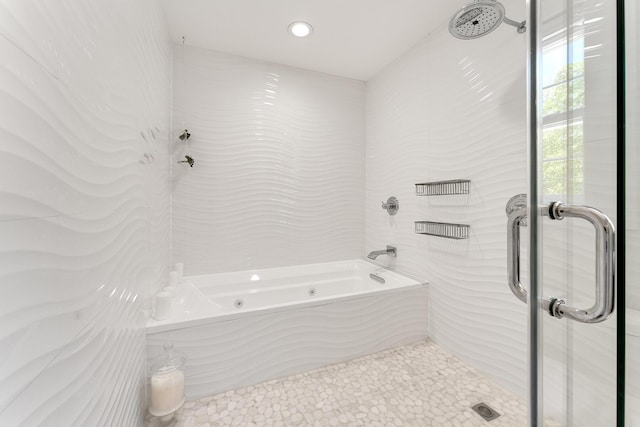 bathroom featuring separate shower and tub and tile walls