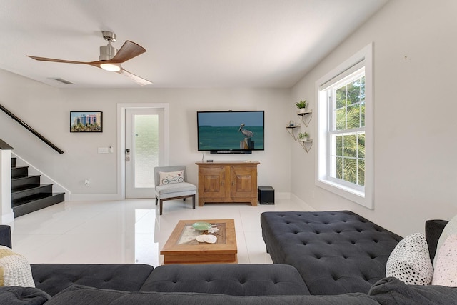 living room with light tile patterned flooring and ceiling fan