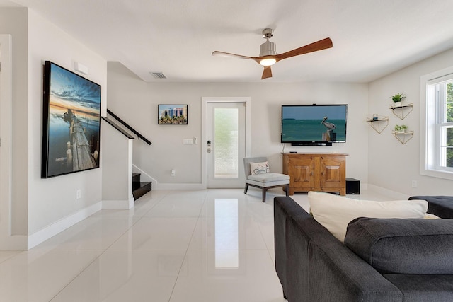 tiled living room featuring ceiling fan