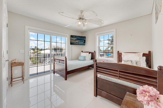 bedroom with access to exterior, light tile patterned floors, and ceiling fan