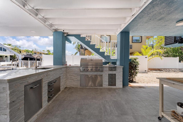 view of patio with area for grilling and sink