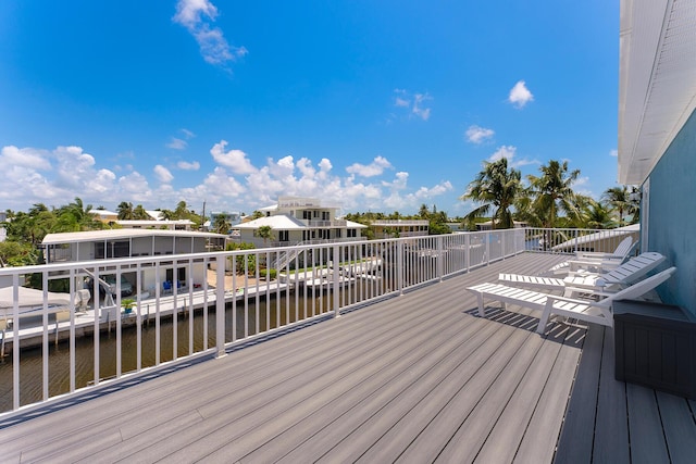 wooden terrace featuring a water view