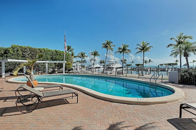 pool featuring fence and a patio